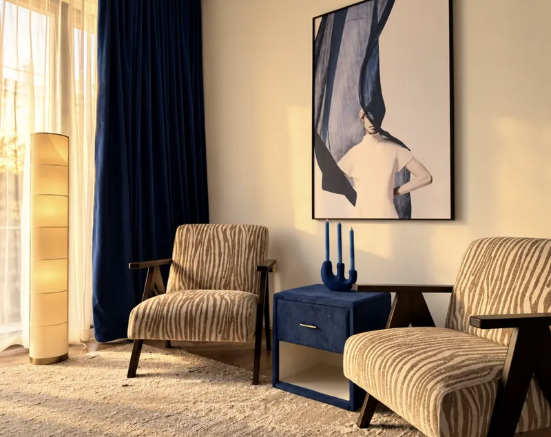 Sitting corner with two zebra-pattern armchairs, navy side table, paper floor lamp and navy velvet curtains