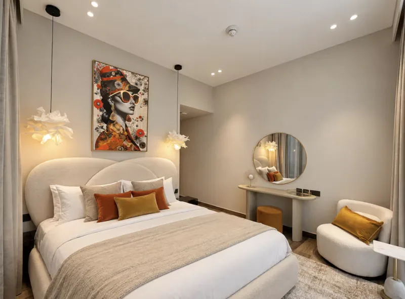 Mirage cream bedroom opening onto a terrace with a white bench
