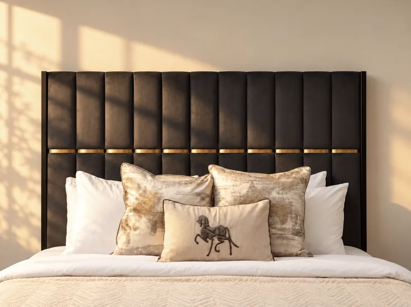 Black and brass channel-tufted headboard with metallic cushions and an embroidered horse cushion