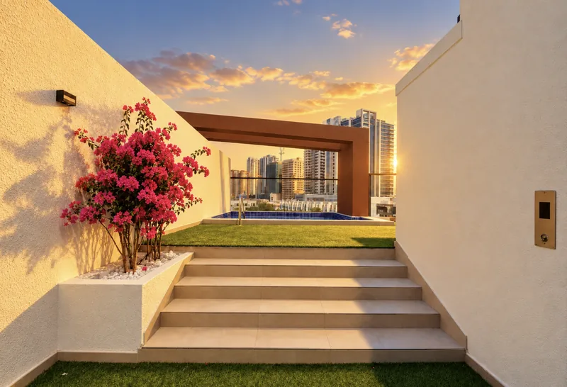 Steps up to the ParkView roof terrace with pink bougainvillea, lawn and the plunge pool beyond