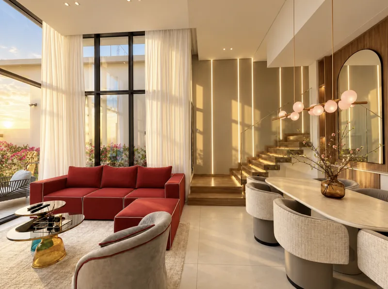 Pearl open-plan living and dining with red modular sofa, grey dining chairs, pink globe chandelier and double-height windows