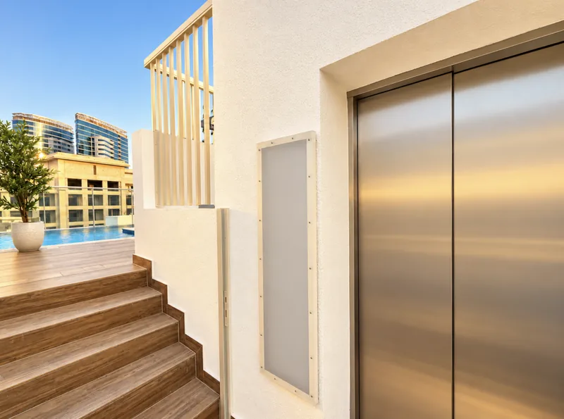 Pearl rooftop terrace with stainless-steel lift, wood-tiled stairs and pool beyond
