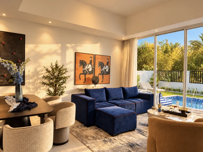 Yasmin lounge and dining area with orange horse artwork and pool view