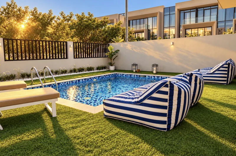Yasmin pool and lawn with striped bean bags and sun loungers