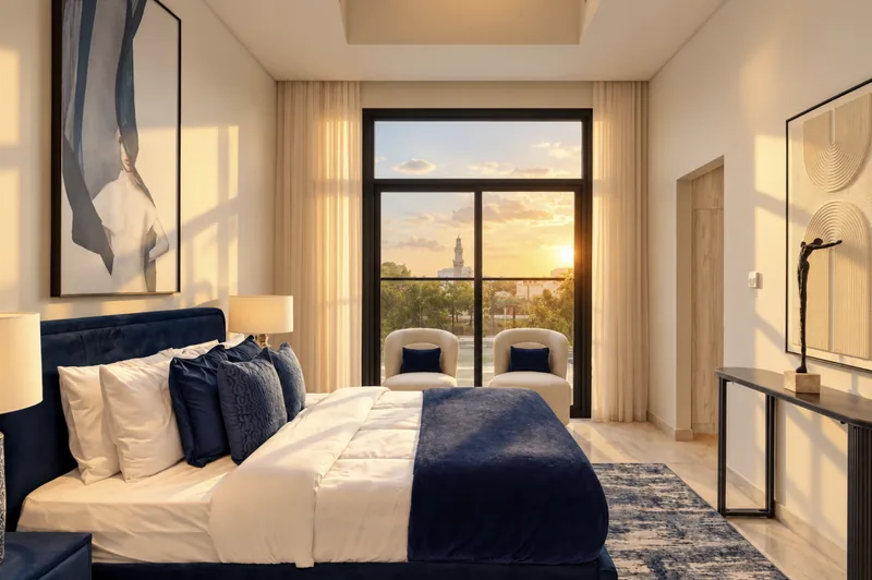 Zephyr bedroom with navy headboard, abstract blue artwork and balcony doors at sunset